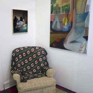 Photo Of Gallery, Two Paintings In Situ With Recliner And Knit Blanket On Green Rug